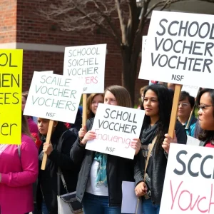 Parents and teachers rallying against the expansion of school vouchers