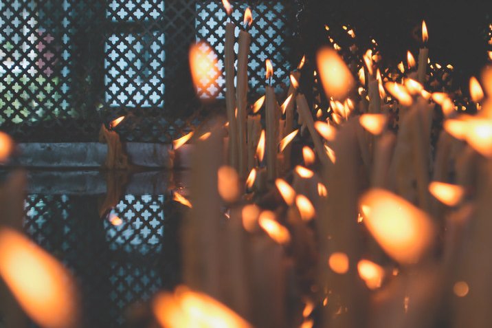 Rows of lit votive candles