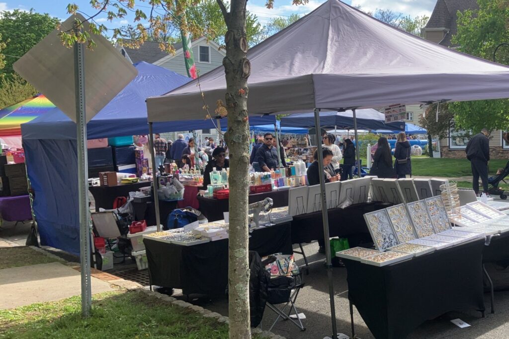 Vendor tents and shoppers at an outdoor street fair